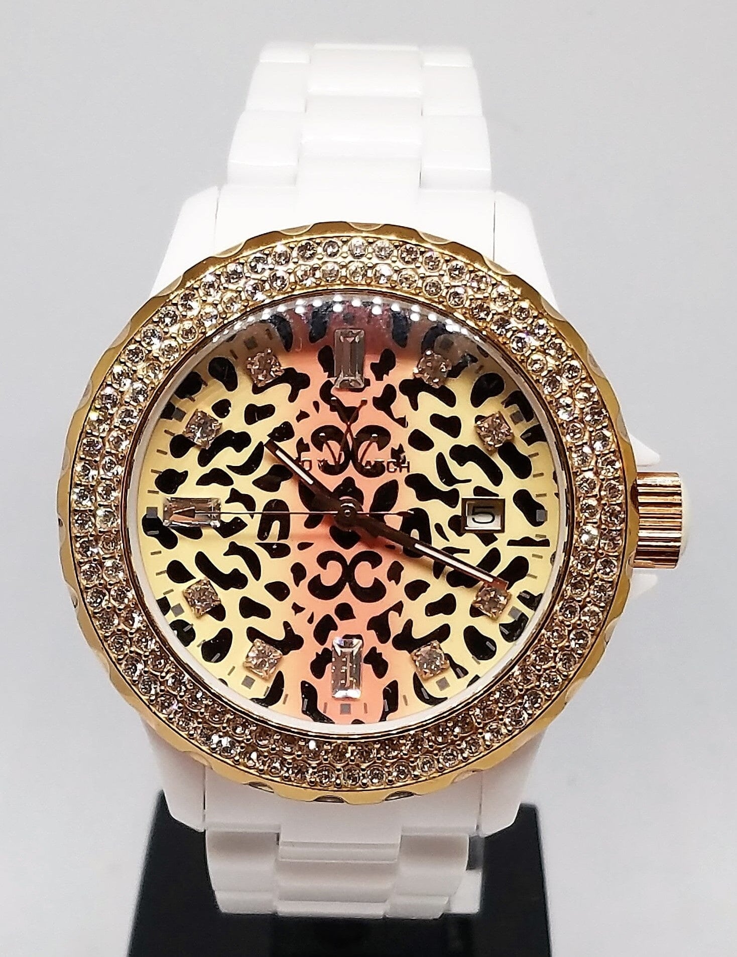 White plasteramic toy watch by Designer Gifts featuring a safari leopard dial with Swarovski crystal markers.